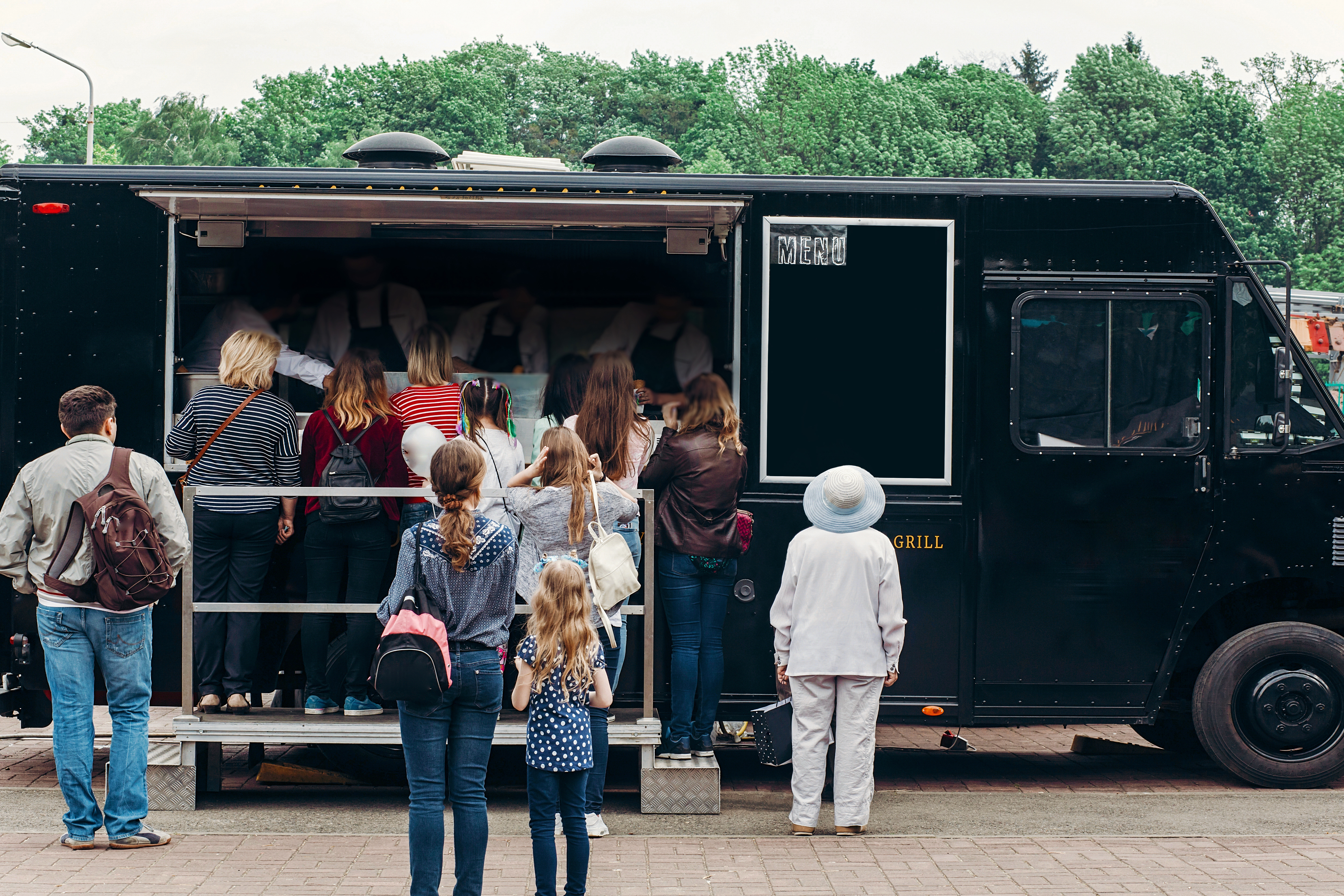 Group of people waiting in line for a food truck